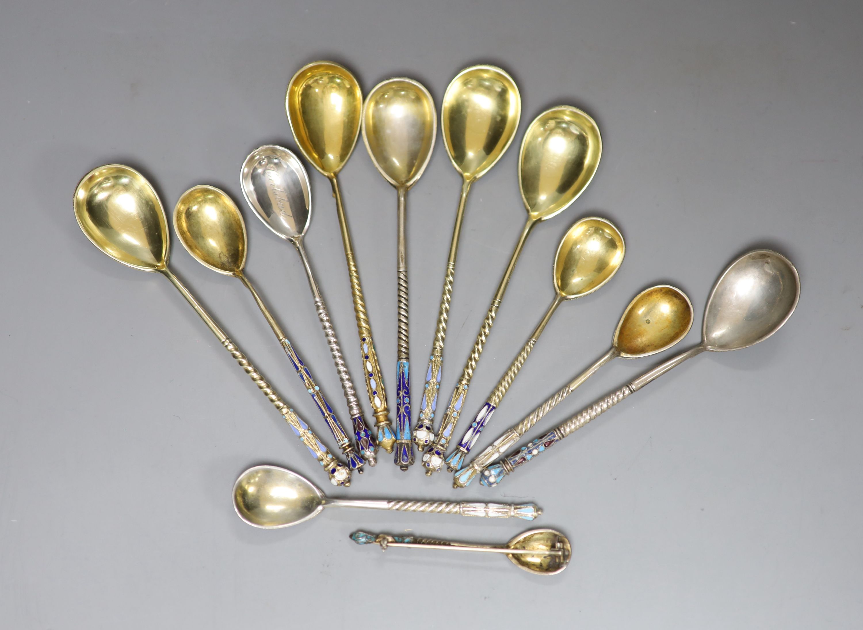 A small collection of twelve assorted late 19th/early 20th century Russian 84 zolotnik and cloisonne enamel teaspoons, etc